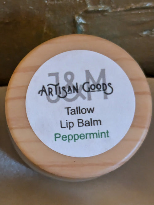 'J&M Artisan Goods' Peppermint Tallow Lip balm, with wooden lid.